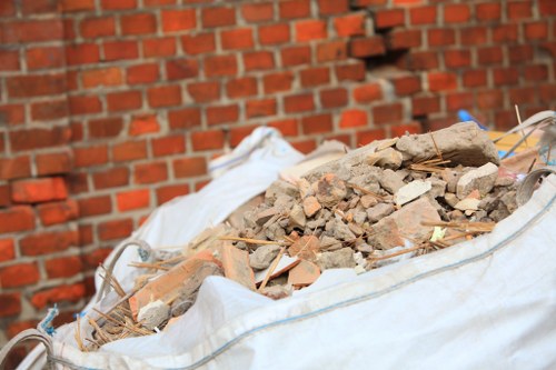 Builders placing a skip on a construction site in Greenwich